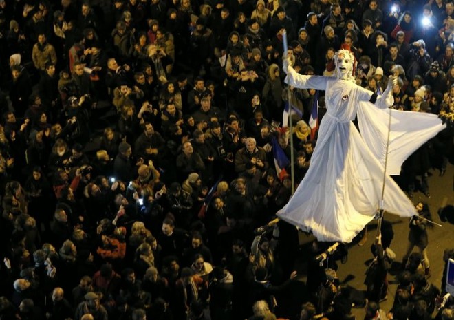 706826-a-giant-figure-depicting-marianne-is-surrounded-by-hundreds-of-thousands-of-french-citizens-taking-p