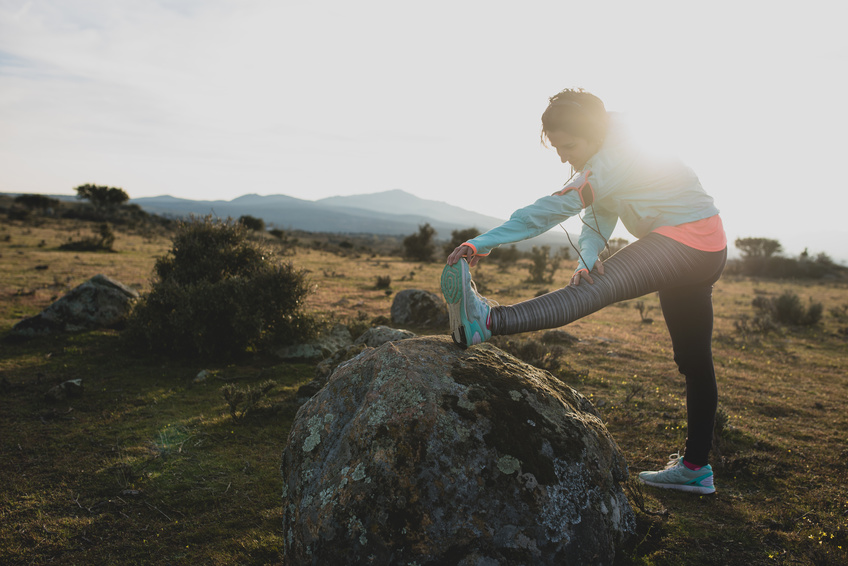 Woman doing stretching in the woods